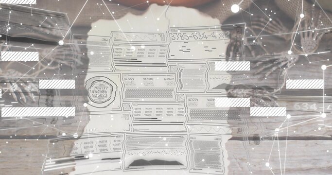 Studying hands in knit sleeves holding torn document with stamp on wood tabletop, digital overlay