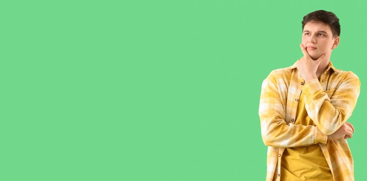 Thoughtful young man on green background with space for text - Powered by Adobe
