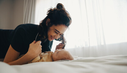 Mother smiles at baby during intimate moment