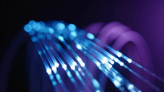 Blue and purple fiber optic cables glow with illuminated tips in abstract. Speed internet and broadband network infrastructure transmits digital data through telecommunications technology. Light - Powered by Adobe
