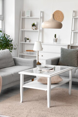 Interior of light living room with grey sofas and coffee table