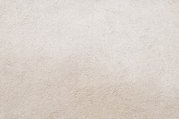 Texture of a smooth, light-colored wall with subtle details and imperfections captured in natural light