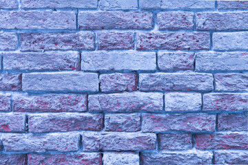 Textured blue brick wall with varying shades and patterns providing a unique urban backdrop in a modern setting