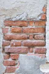 Exposed brick wall with layered textures showcasing wear and history in an old building