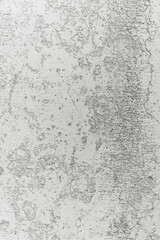 Abstract textured surface with gray and white patterns showing wear and age