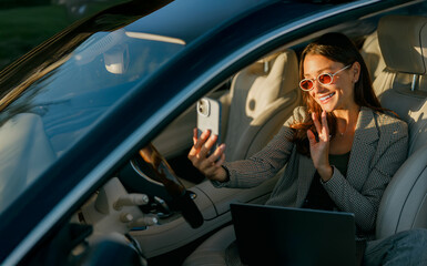Woman taking selfie inside car, flashing peace sign with playful smile and sunglasses, car interior frames fashionable creator
