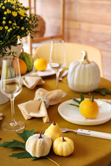 Autumn table setting with flowers and pumpkins