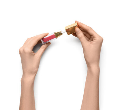 Female hands with pink lip gloss on white background