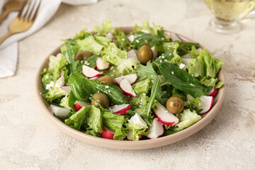 Plate with healthy salad on grunge background
