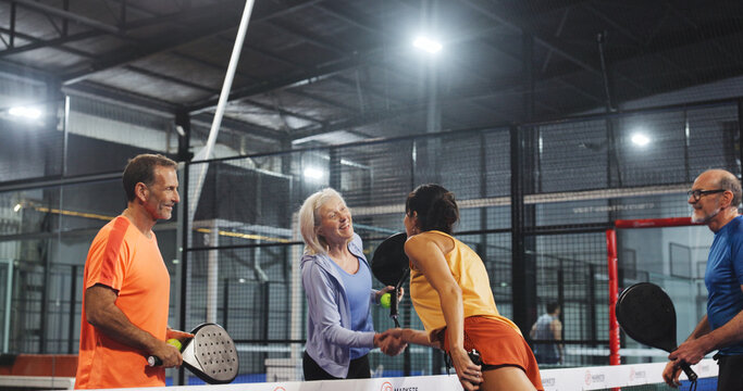 Padel, athletes and greeting with handshake, court and gesture for friendly match, fitness and sport. Tennis players, challenge and shaking hands for introduction, mature people and together for game