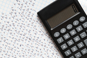 Obraz premium Copybook with handwritten maths formulas and calculator as background, closeup