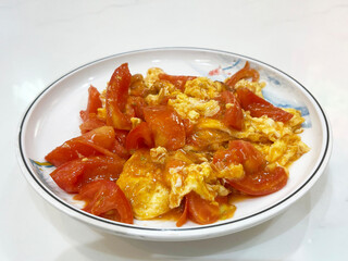 A plate of classic Chinese stir-fried tomato and eggs.