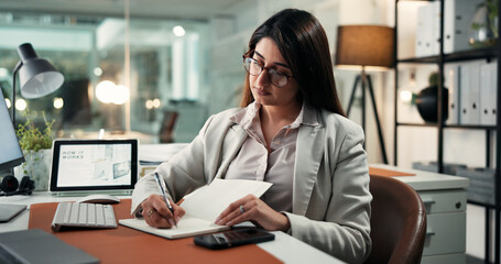 Notebook, writing and businesswoman in office with research for finance agenda or reminder. Plan,...