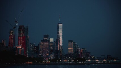 Downtown Manhattan at Dusk with Glowing Skyscrapers and Waterfront Reflections - Powered by Adobe
