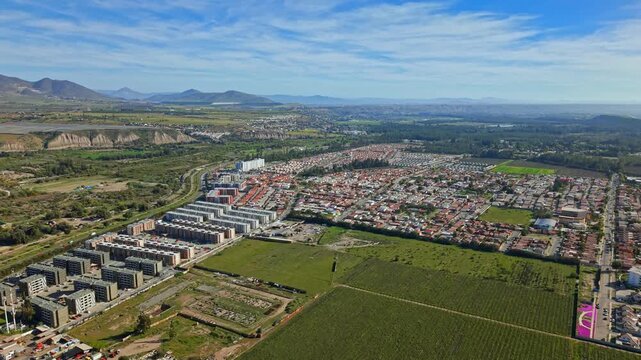 Flying over the city of Ovalle with grape plantations in the Limar&iacute; Valley on a sunny, clear day. Condominiums and green mountains.