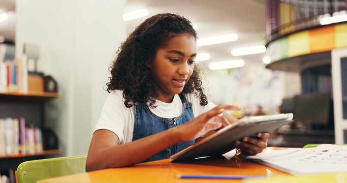 Tablet, education and child in library for research online with studying for test, assignment or exam. Digital technology, learning and girl kid student reading information on app for knowledge.