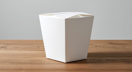 Blank white takeout container on light wood table