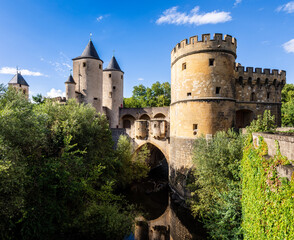 South view of the Germans' Gate, a medieval bridge castle and city gate over the Seille river in Metz, France, with two round towers and two gun bastions, relic of the fortifications.