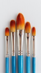 Realistic shot of a set of paintbrushes aligned neatly on a bright white background, art tools theme.