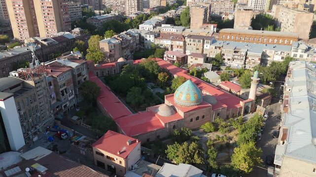 Aerial drone view of the Blue Mosque in Yerevan, Armenia. The footage shows the beautiful Persian-style mosque surrounded by city buildings in downtown Yerevan. 