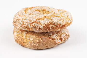 Two beautiful delicious ring cakes with sugar sprinkles on a white background.