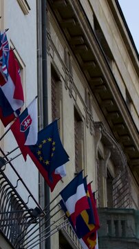 European and National Flags Waving on Historic Prague Building