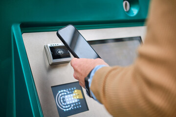 close up shot of man paying contactless with smartphone. unrecognizable person