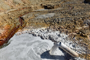 Acidic mine residual water drainage, flowing into decanting pond