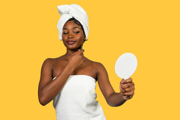 Young black woman doing neck gua sha routine