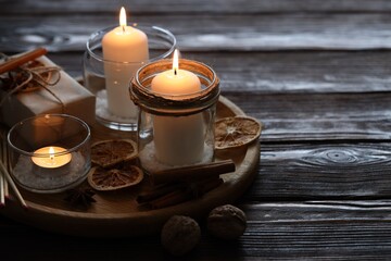 Christmas lanterns, matches and spices on wooden table, closeup. Space for text