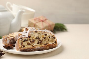 Slices of Stollen (traditional Christmas cake) served on white table, closeup. Space for text