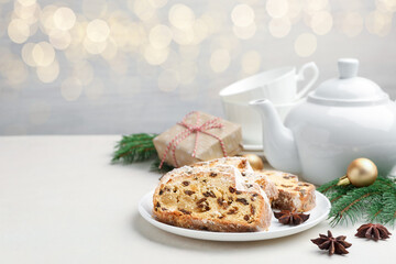Slices of Stollen (traditional Christmas cake) served on white table. Space for text