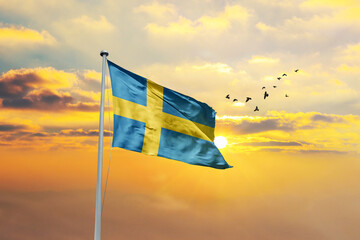 Sweden flag waving in sunset or sunrise. Sweden flag for Republic Day and Independence Day.