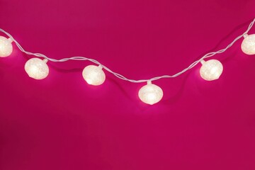 a string of lights on a pink background