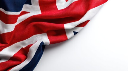 United Kingdom flag stretched diagonally across frame, photographed against seamless white background. Clean studio lighting produces natural shadows