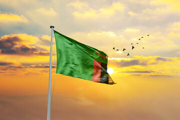 Zambia flag waving in sunset or sunrise. Zambia flag for Republic Day and Independence Day.