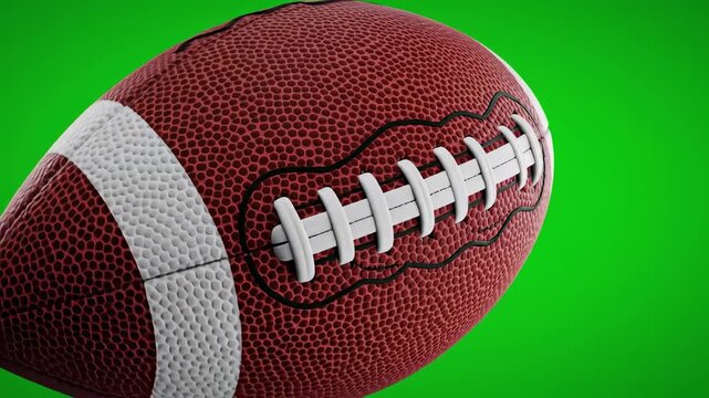 A close-up view of a leather-textured oblong ball. It has white stitching and a white line detailing. The background is a bright green color