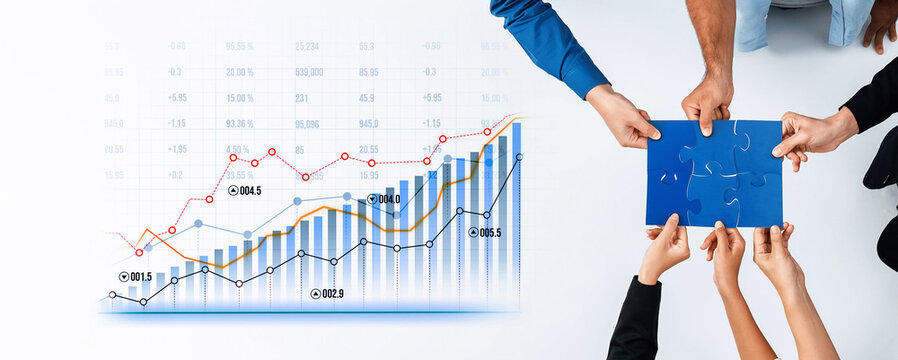 Diverse hands reach for puzzle pieces while surrounded by growth charts in a strategic meeting, symbolizing teamwork and data-driven decision making in business. Scalp