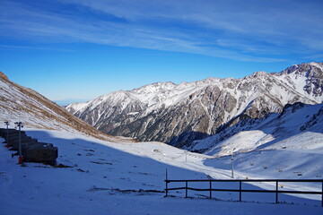 Medeo. A mountain gorge, with different vegetation and fir trees. First snow.