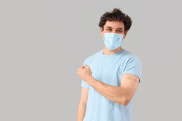 Young man in medical mask after vaccination on light background. Immunity concept