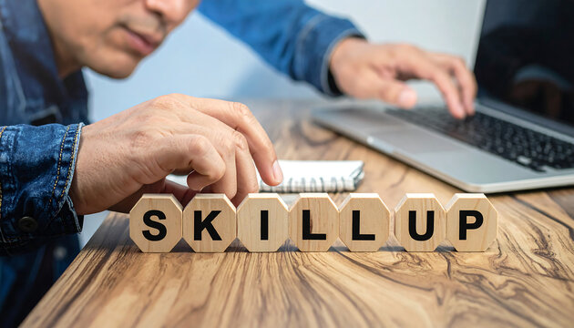 Learning and development with a person typing on a laptop and wooden blocks spelling 'SKILL UP'