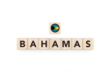 Wooden blocks bearing the name and flag of Bahamas. Bahamian and Caribbean Culture, national identity, travel, and geography in a copy space design.