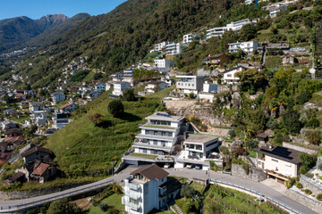 Naklejka premium Aerial view of a group of houses in Switzerland in a mountainous part of the south of the country