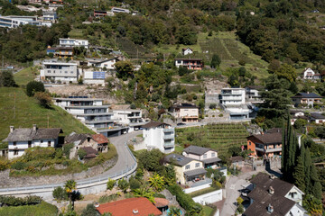 Naklejka premium Aerial view of a group of houses in Switzerland in a mountainous part of the south of the country