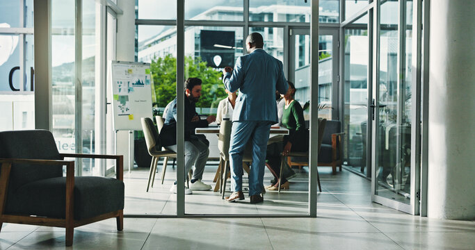 Businessman, coach and discussion with team for corporate performance, revenue or statistics. Man, employee or speaker with group for presentation, business analytics or company progress in workplace