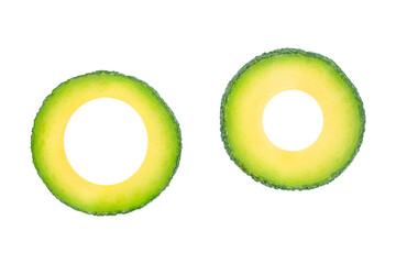 Two avocado rings isolated, creative green tropical fruit slices with copy space for text, healthy organic food and minimalist design concept for advertising or banner