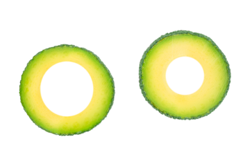 Two avocado rings isolated, creative green tropical fruit slices with copy space for text, healthy organic food and minimalist design concept for advertising or banner