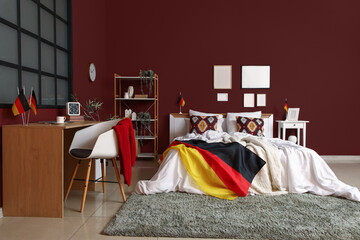 Interior of bedroom with German flags and workplace
