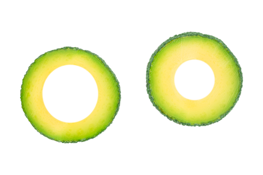 Two avocado rings isolated, creative green tropical fruit slices with copy space for text, healthy organic food and minimalist design concept for advertising or banner