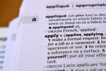 Close Up Of English Dictionary Page With Word - apply